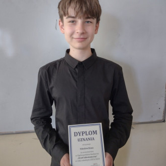 Uczeń z dyplomem uznania za udział w konkursie informatycznym
